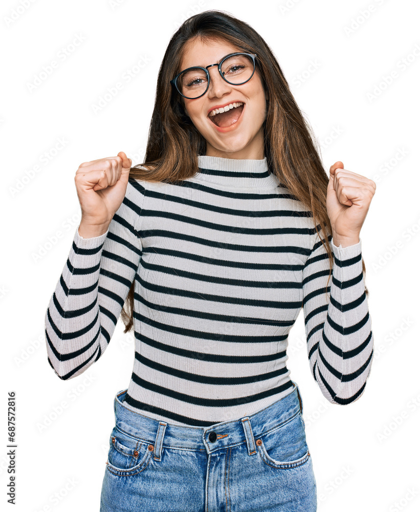 Wall mural young beautiful teen girl wearing casual clothes and glasses celebrating surprised and amazed for su