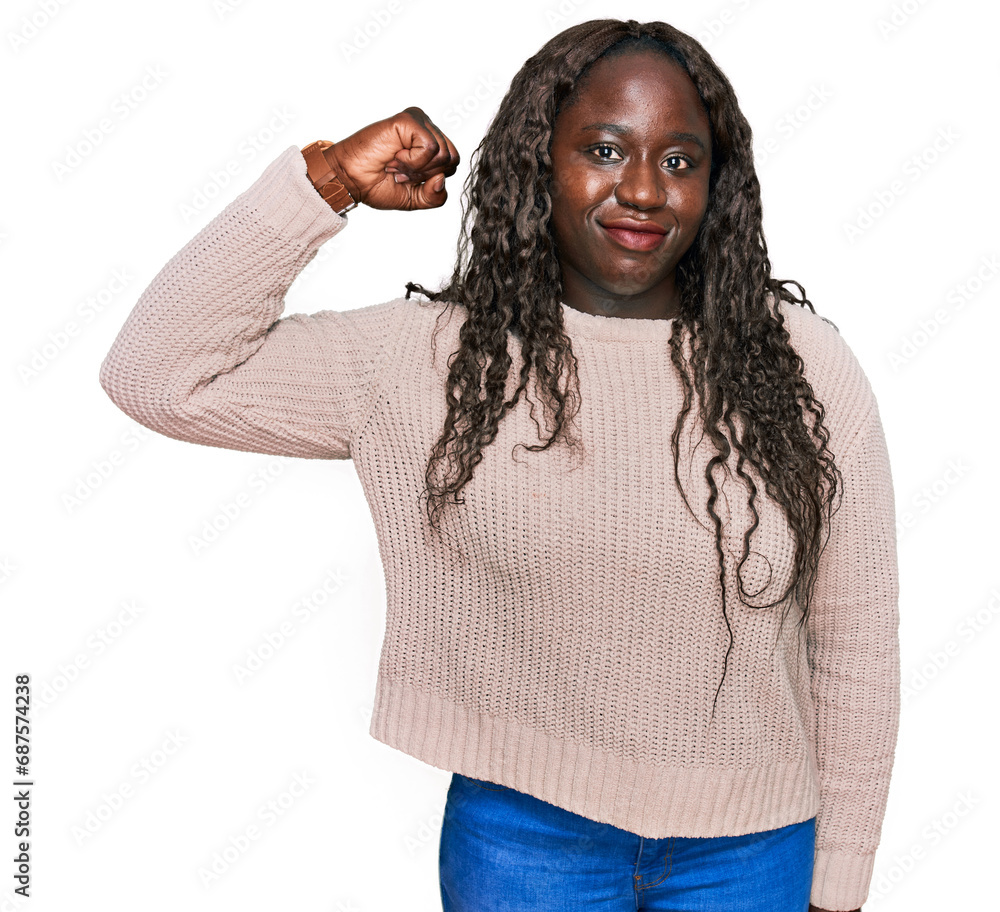 Poster Young african woman wearing wool winter sweater strong person showing arm muscle, confident and proud of power