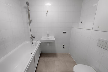 Bathroom in a new apartment. Freshly renovated bathroom with toilet, shower, sink. New apartment building, economy version of the bathroom
