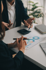 Financial analysts analyze business financial reports on a digital tablet planning investment...