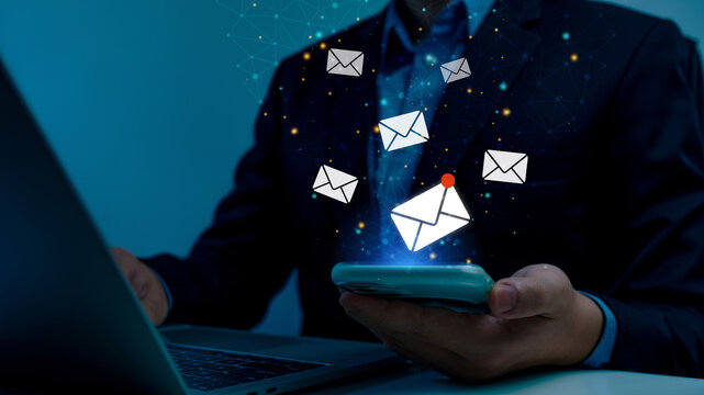 Businessman using smart phone with virtual new email notification alert concept for business e-mail communication and digital marketing. Inbox receiving electronic message alert, internet technology. - Powered by Adobe