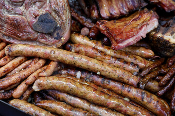 Grilled steak,traditional sausage and different tipe of meat prepared on grill.