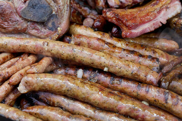 Grilled steak,traditional sausage and different tipe of meat prepared on grill.