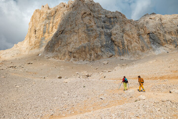 two girls with backpacks on a hike. hiking and travel in the mountains.