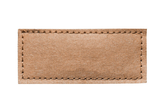 Brown leather belt strap closeup isolated on white. Brown stitched leather seam frame label tag isolated on white. Empty copy space fashion background.