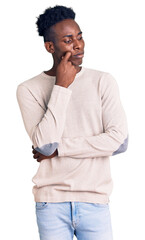 Young african american man wearing casual clothes serious face thinking about question with hand on chin, thoughtful about confusing idea