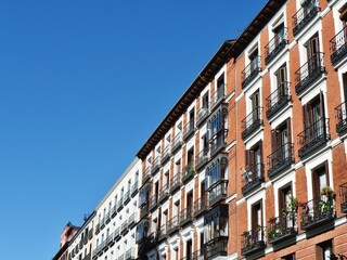Fototapeta na wymiar Vintage facades with windows and balconies downtown Madrid, central district, Spain