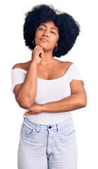 Young african american girl wearing casual clothes serious face thinking about question with hand on chin, thoughtful about confusing idea