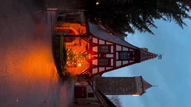 Street decorated for New Year and Christmas Market in Rothenburg ob der Tauber, Bavaria, Germany December 22, 2022. Vertical video. High quality 4k footage
