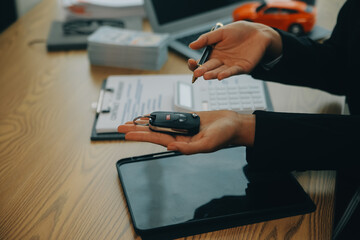 Salesman send key to customer after good deal agreement, successful car loan contract buying or selling new vehicle.