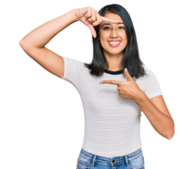 Beautiful asian young woman wearing casual white t shirt smiling making frame with hands and fingers with happy face. creativity and photography concept.