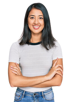 Beautiful asian young woman wearing casual white t shirt happy face smiling with crossed arms looking at the camera. positive person.