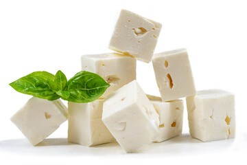 Cube Feta cheese isolated on white background clipping Heap of Feta cheese, basil leaves and tomatoes.