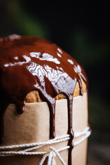 Christmas Panettone Cake with Melted Chocolate on Rustic Wooden Board and Festive Decorations - Holiday Dessert from Milan, Italy. 