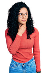 Young hispanic woman with curly hair wearing glasses touching painful neck, sore throat for flu, clod and infection