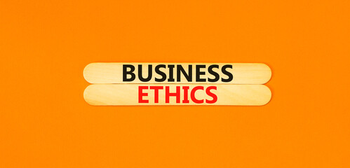 Business ethics symbol. Concept words Business ethics on beautiful wooden stick. Beautiful orange...