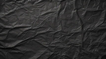 Black crumpled paper texture in low light background