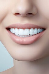 Fototapeta premium A close-up photo of the lower part of a female face. Beautiful, cute smile with immaculate, perfect teeth. Chin, nose, and mouth visible.