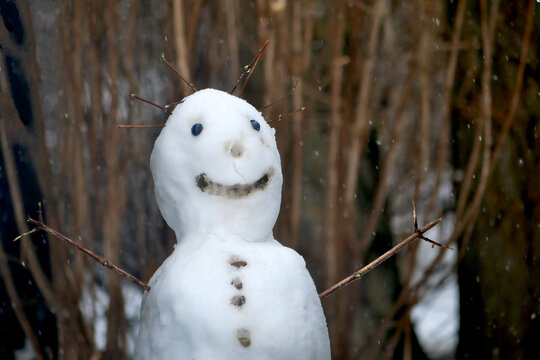snowman with a big smile in a warm winter day short before melting
