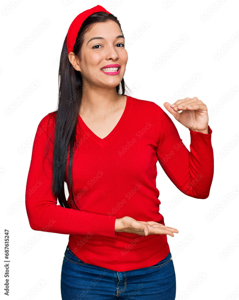 Sticker young hispanic woman wearing casual clothes gesturing with hands showing big and large size sign, me