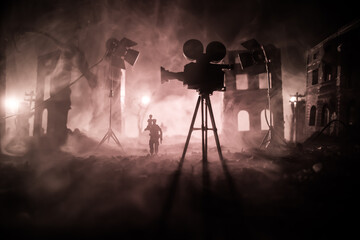 Action (War) movie concept. Man moving out with little boy from burned out city destroyed in war....