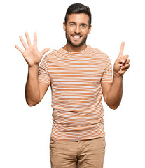 Naklejka premium Handsome hispanic man wearing casual clothes showing and pointing up with fingers number six while smiling confident and happy.