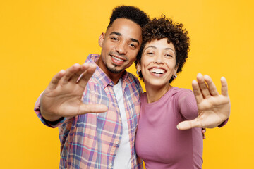 Young happy cheerful couple two friend family man woman of African American ethnicity wear purple...