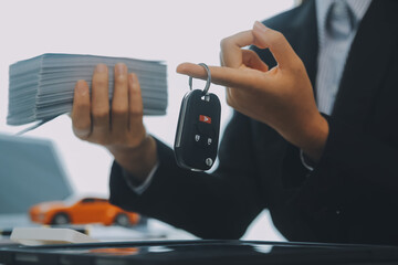 Salesman send key to customer after good deal agreement, successful car loan contract buying or selling new vehicle.