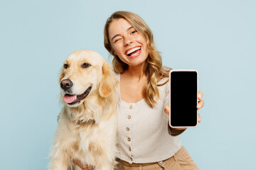 Young owner woman with her best friend retriever wear casual clothes use blank screen area mobile...