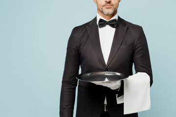 Cropped close up adult barista male waiter butler man wears shirt black suit bow tie uniform hold...