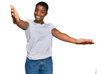 Young african american woman wearing casual white t shirt looking at the camera smiling with open arms for hug. cheerful expression embracing happiness.