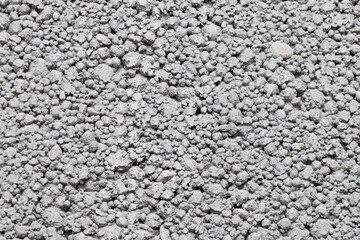 Gray mineral background. Tile adhesive texture. Facade plaster background. Gray plaster grains pattern. Home renovation texture. Granules backdrop. Stucco wall background. Grunge cement texture.