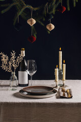 winter holidays, dinner party and celebration concept - scandinavian christmas table serving with burning candles at home over black background