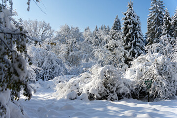 View of a Bavarian winter landscape with lots of snow, blue sky with clouds on a cold winter day