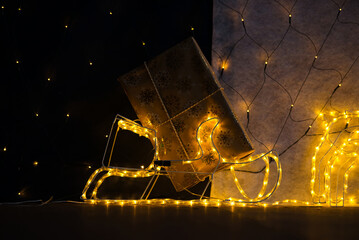 Closeup of Christmas Gift in Golden Paper on Sled