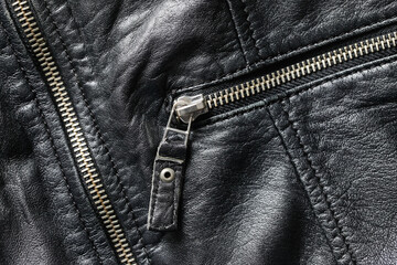 Black leather jacket background. Grunge autumn clothing. Winter fashion texture. Closed fastener pocket. Zipped zipper. Fabric design pattern. Metal silver shiny zipper teeth background. Jacket pocket - obrazy, fototapety, plakaty