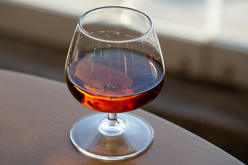 glass of cognac on a wooden table in the bar