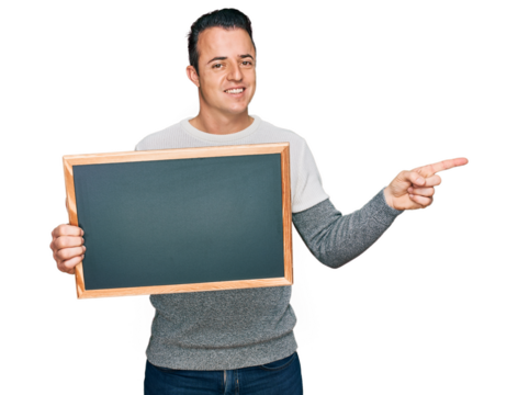 Handsome young man holding blackboard smiling happy pointing with hand and finger to the side