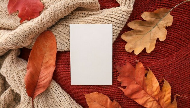 blank paper card mockup fall dried leaves on neutral beige and bright ginger red terracotta knitted textile background aesthetic autumn wedding invitation business brand design template flat lay