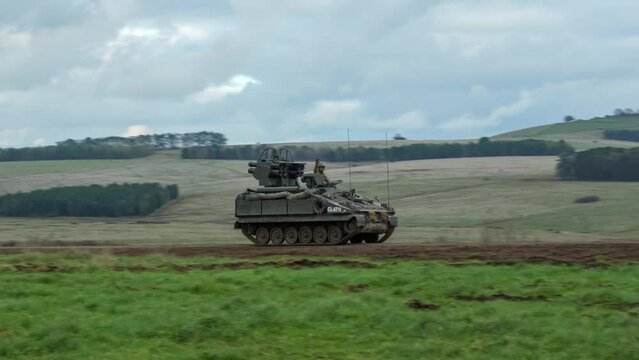 British army Stormer tank equipped with Starstreak HVM (High Velocity Missile) launcher, travelling at speed across countryside