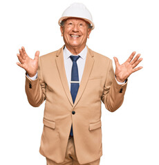 Senior caucasian man wearing architect hardhat celebrating mad and crazy for success with arms raised and closed eyes screaming excited. winner concept