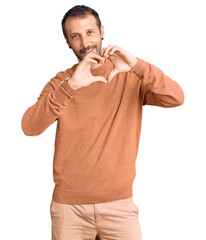 Young handsome man wearing casual clothes smiling in love doing heart symbol shape with hands. romantic concept.