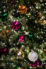 The Christmas tree's green trees, colorful, shiny, and ornaments are beautiful.