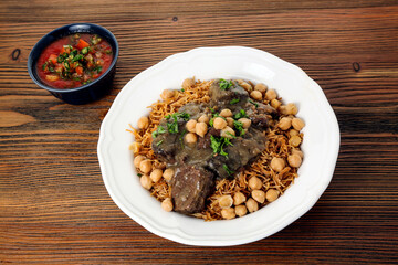 Noodle kebab halla braised beef noodles with chilli sauce served in dish isolated on table top view of arabic food