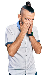 Hispanic man with ponytail wearing casual white shirt rubbing eyes for fatigue and headache, sleepy...