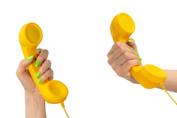 Yellow handset in woman hand with green nails isolated on a white background. - obrazy, fototapety, plakaty
