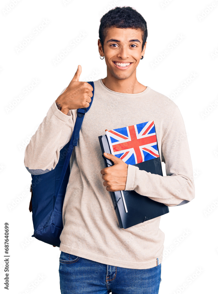 Wall mural Young african amercian man wearing student backpack holding binder and uk flag smiling happy and positive, thumb up doing excellent and approval sign