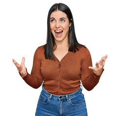 Young hispanic woman wearing casual clothes crazy and mad shouting and yelling with aggressive...
