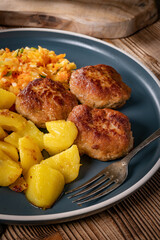 Meatballs  served with fired potatoes.