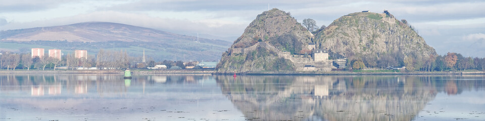 Dumbarton castle on volcanic rock overlooking the River Clyde with Ben Lomond in the background